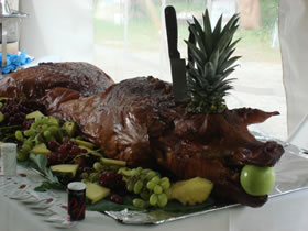 Pig with fruit on table